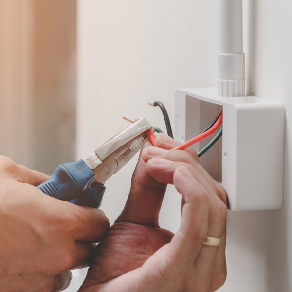 man installing wiring