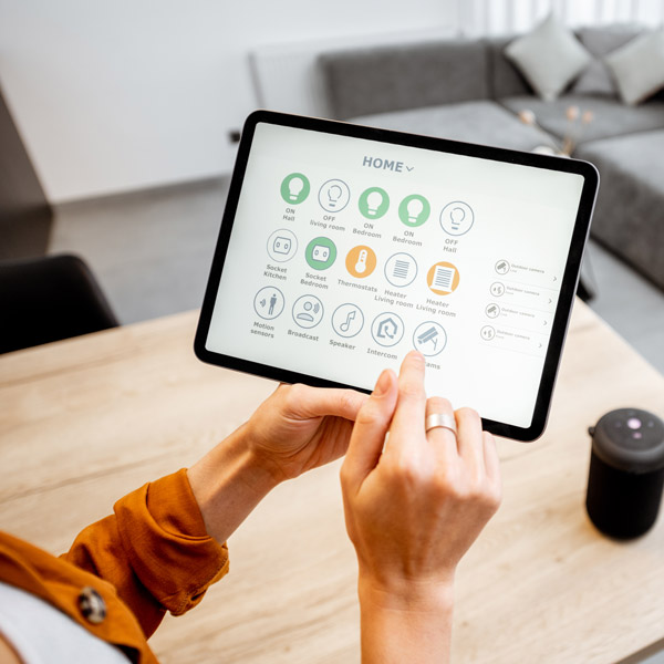 woman holding tablet with home automation options