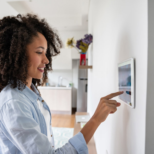 woman setting home alarm