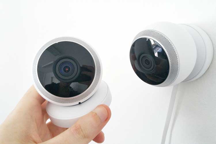 Two CCTV camera and man's hand